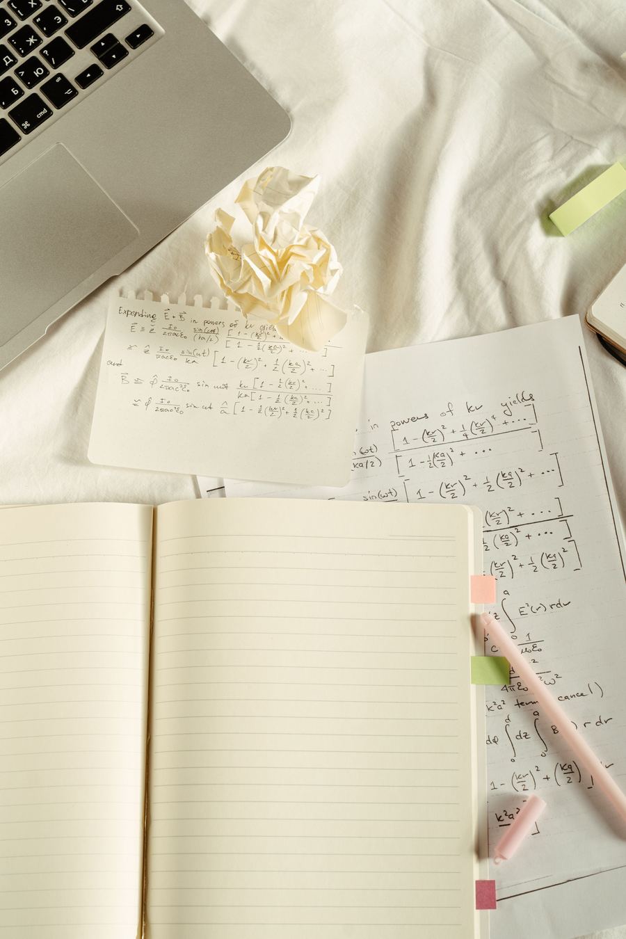 Handwritten physics notes and worked equations